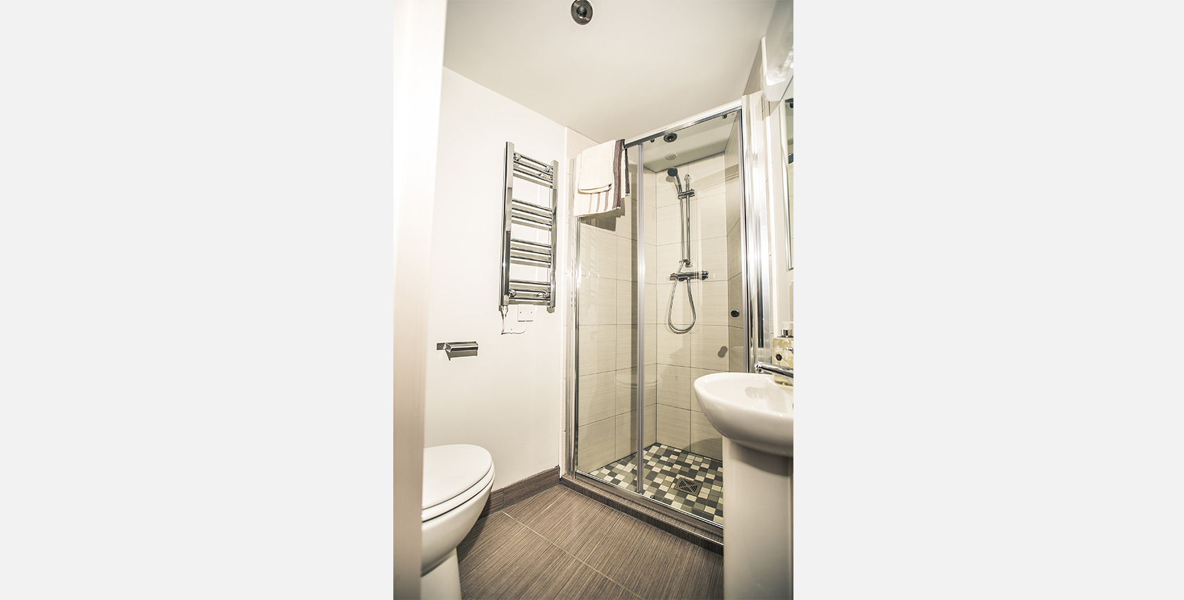 Bathroom in Trinity Court showing white shower and sink.