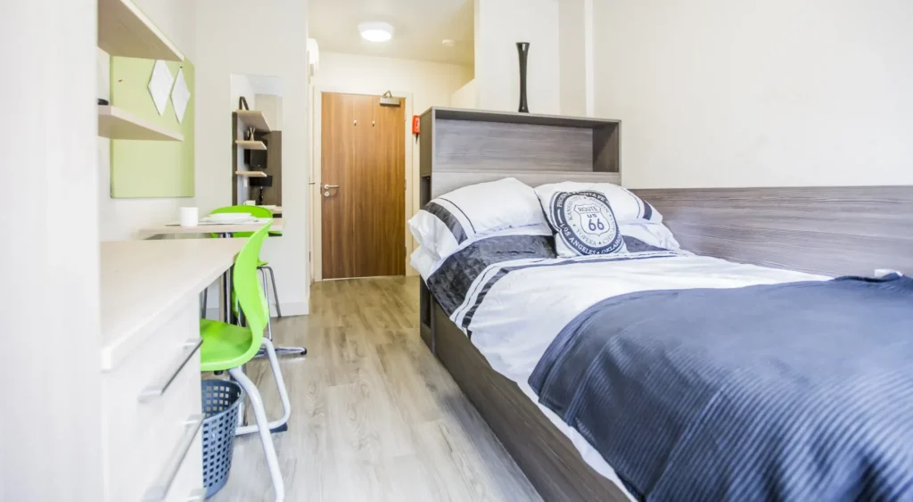 Room with bed and 2 seating areas.