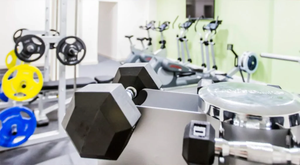 View of the gym at Clyde House with cycle machines and weights.